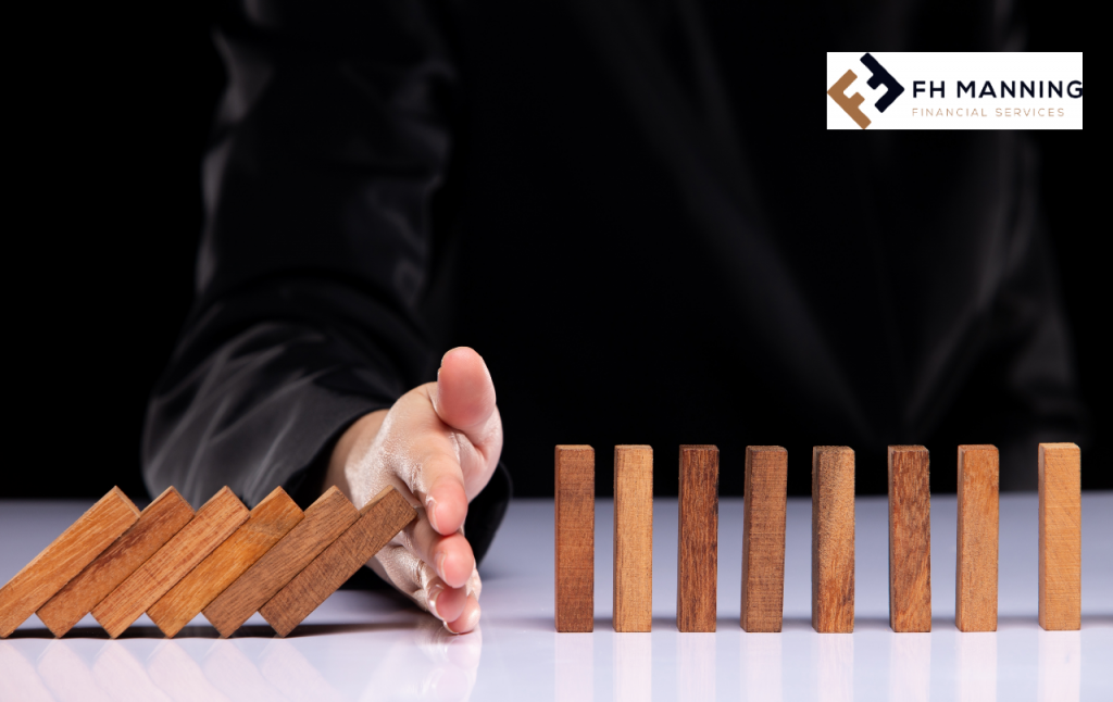 FH Manning Financial Services - Hand stopping dominoes