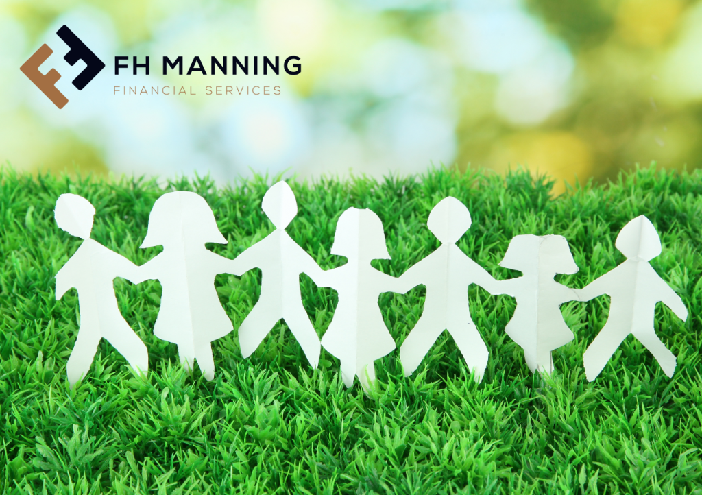 Paper cutouts of a group holding hands on grass