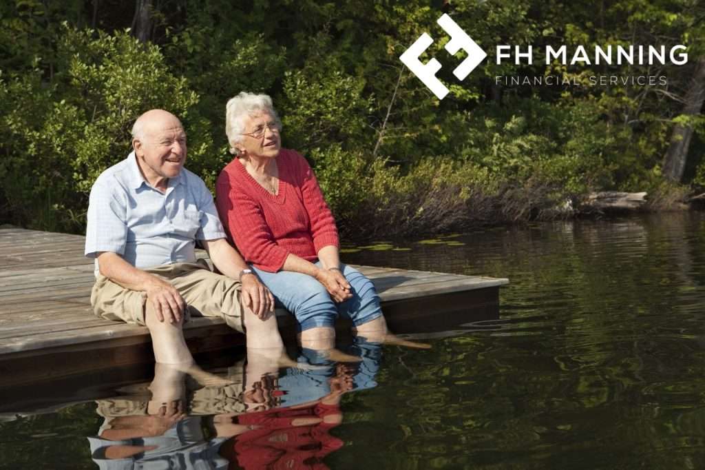 Old couple dangling feet in river