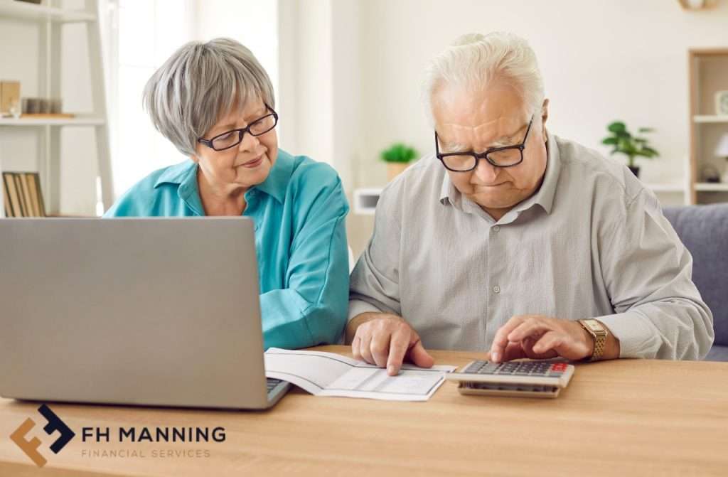 Old couple with calculator working out pension