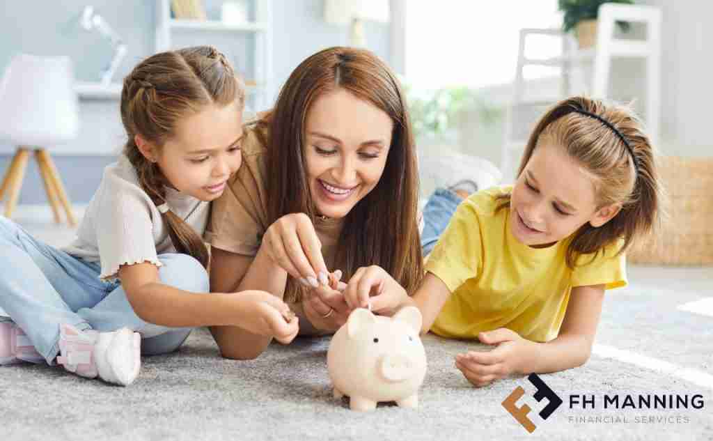 Mum on floor with daughters and piggy bank